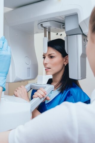 Dentist taking scans of a womans mouth and jaw