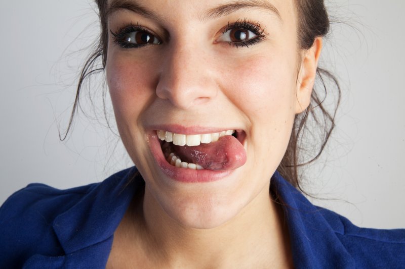 Patient smiling after getting a dental crown